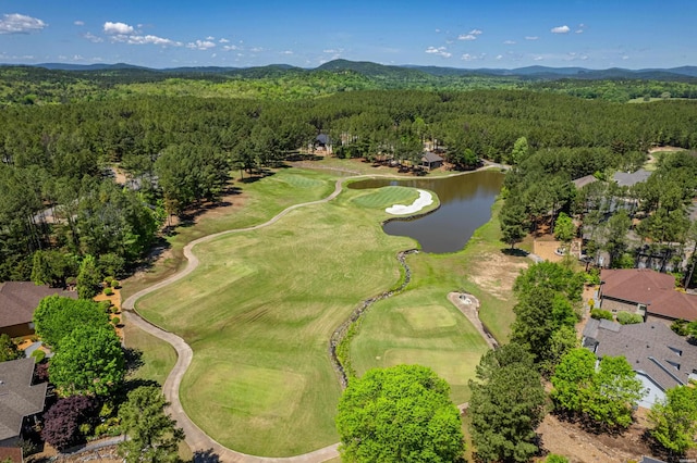 drone / aerial view featuring a water and mountain view, a forest view, and golf course view