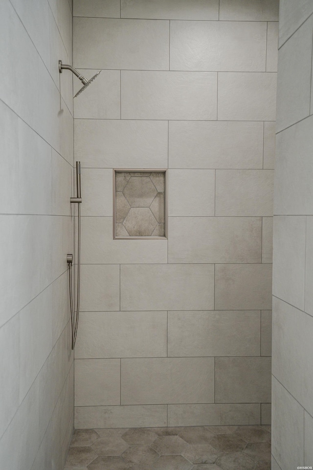full bath with a tile shower