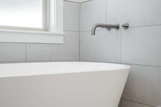bathroom with a freestanding tub