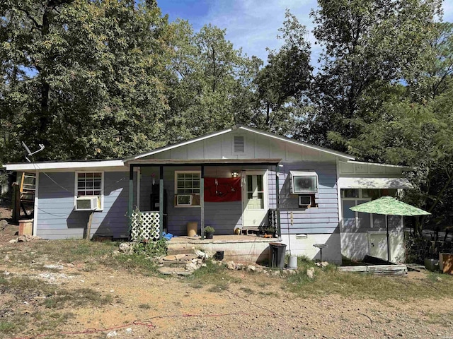 view of front of house featuring board and batten siding and cooling unit