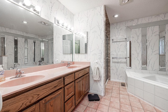 full bath with a sink, a bath, and wallpapered walls