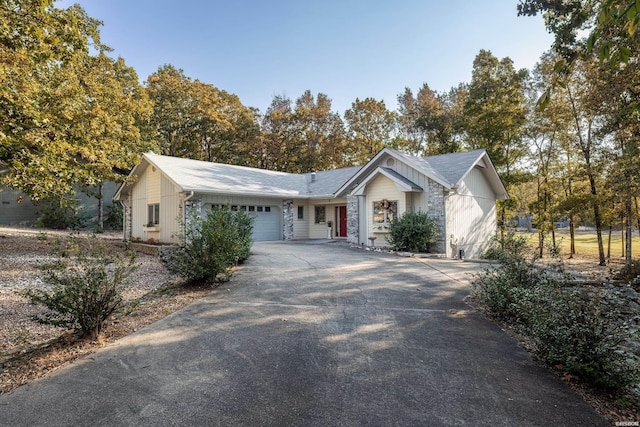 ranch-style home featuring a garage and concrete driveway