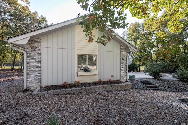 view of side of property with stone siding