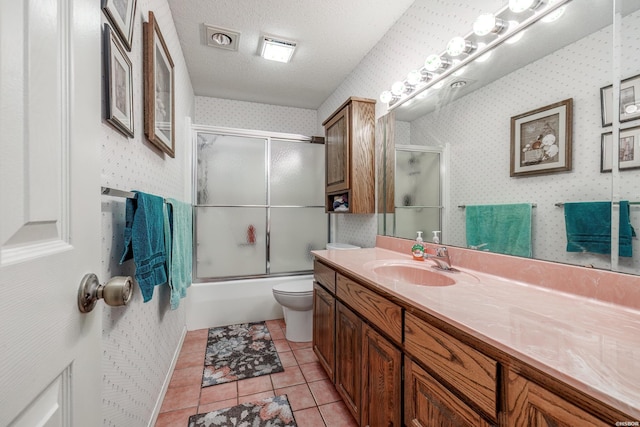 full bath featuring enclosed tub / shower combo, a textured ceiling, vanity, tile patterned floors, and wallpapered walls