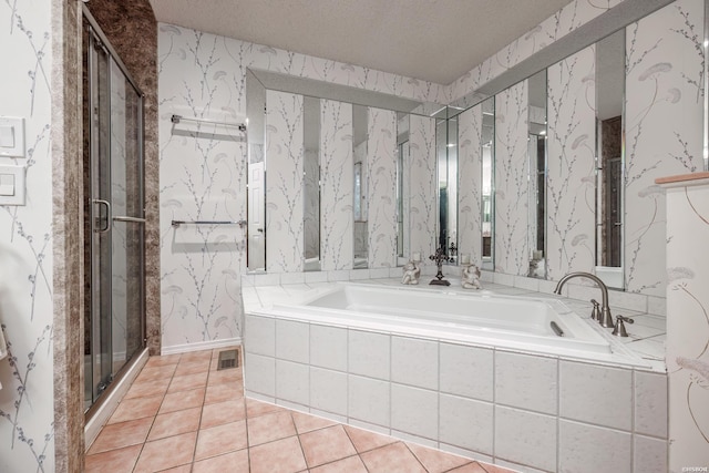 full bathroom with a textured ceiling, tile patterned flooring, a bath, and wallpapered walls