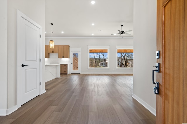 unfurnished living room featuring ceiling fan, dark wood-type flooring, recessed lighting, and baseboards