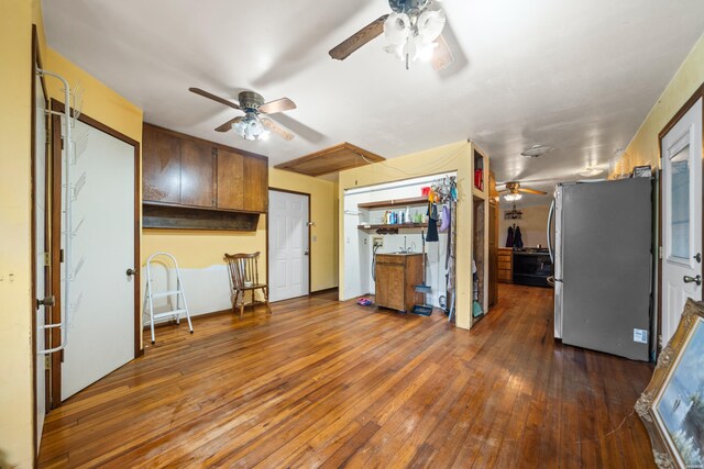 kitchen with a ceiling fan, freestanding refrigerator, and dark wood finished floors