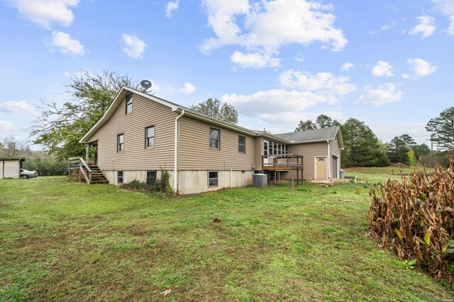 back of house with a lawn, a deck, and central AC unit