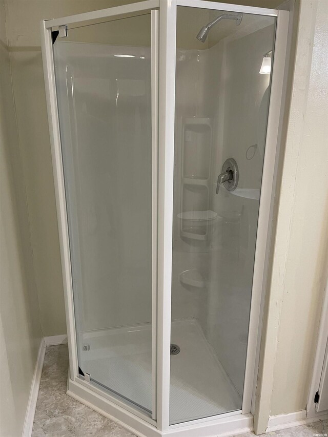 full bath featuring a shower stall