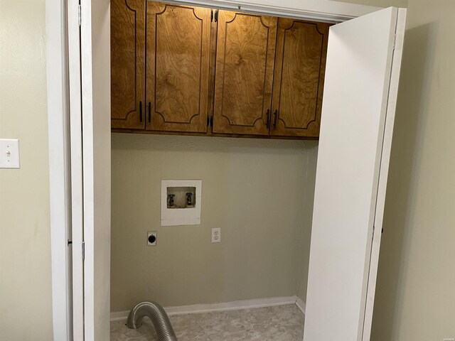 washroom featuring hookup for a washing machine, cabinet space, electric dryer hookup, and baseboards