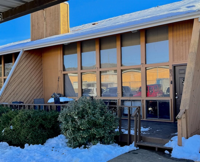 view of snow covered property entrance