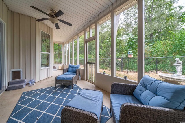 sunroom / solarium featuring a healthy amount of sunlight and ceiling fan