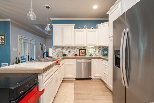 kitchen with a sink, white cabinetry, light countertops, stainless steel refrigerator with ice dispenser, and decorative light fixtures