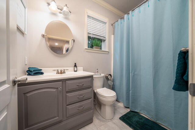 bathroom with toilet, tile patterned flooring, crown molding, and vanity