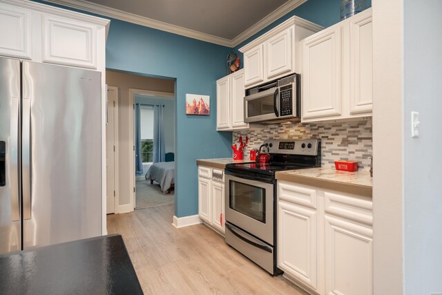 kitchen featuring crown molding, decorative backsplash, appliances with stainless steel finishes, light wood-style floors, and white cabinetry