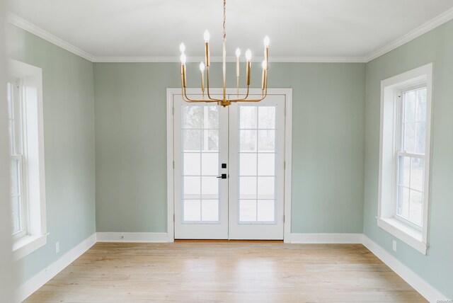 doorway to outside with crown molding, french doors, baseboards, and light wood-style floors