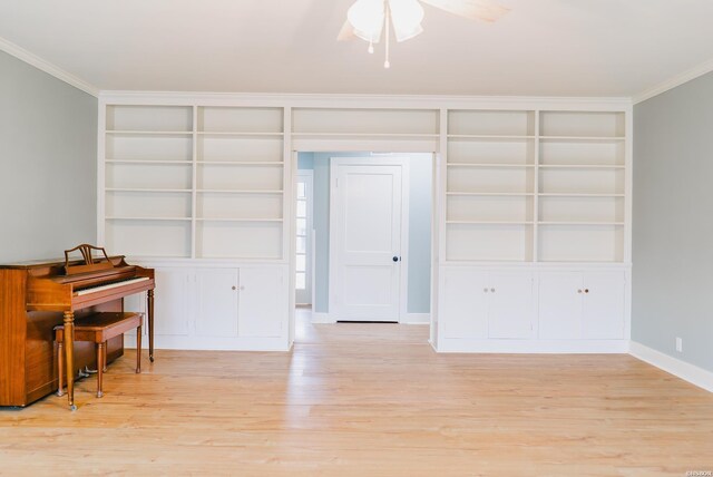 interior space featuring light wood-style floors, baseboards, and ornamental molding