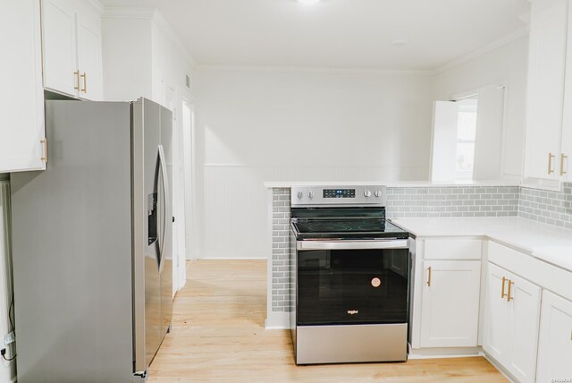 kitchen with white cabinets, light wood finished floors, appliances with stainless steel finishes, and light countertops