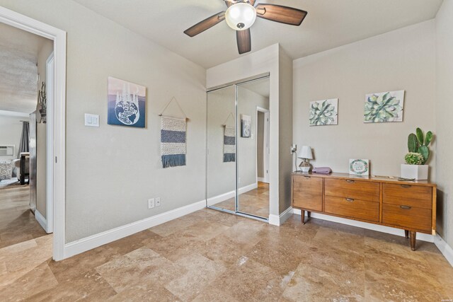 bedroom featuring a ceiling fan, baseboards, and a closet