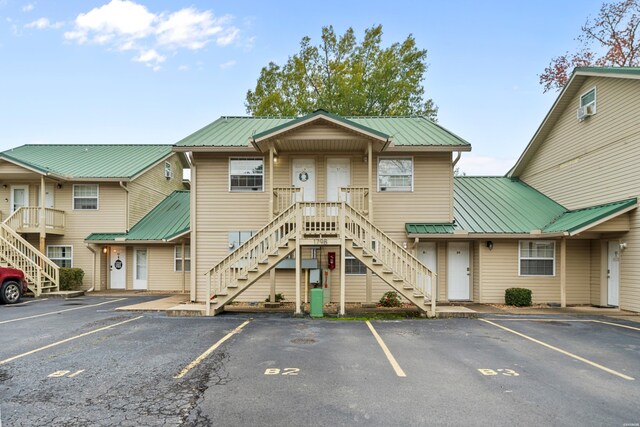 view of building exterior with uncovered parking