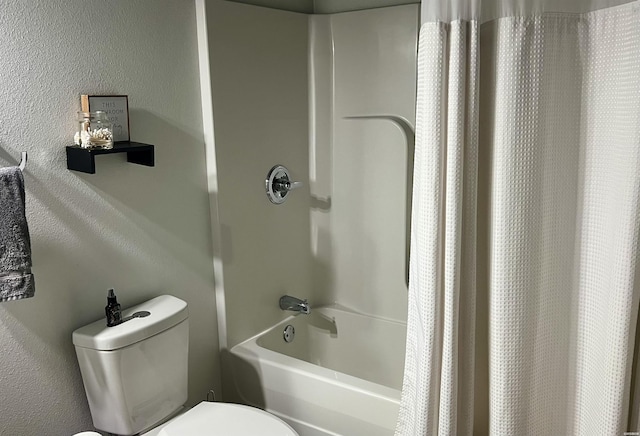 full bath featuring a textured wall, shower / tub combo, and toilet