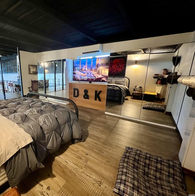 bedroom featuring access to outside, a wall mounted AC, and wood finished floors