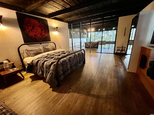 bedroom with wood ceiling, wood finished floors, access to outside, floor to ceiling windows, and beam ceiling