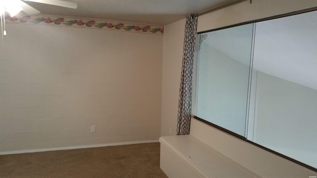 carpeted empty room featuring ceiling fan