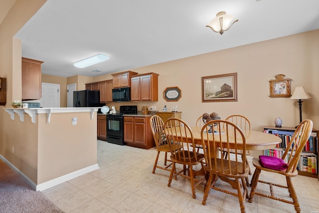 dining room with light tile patterned floors and baseboards