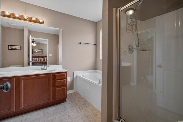 ensuite bathroom with a stall shower, connected bathroom, tile patterned flooring, vanity, and a bath