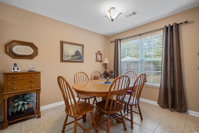 dining area featuring visible vents, baseboards, and light tile patterned floors