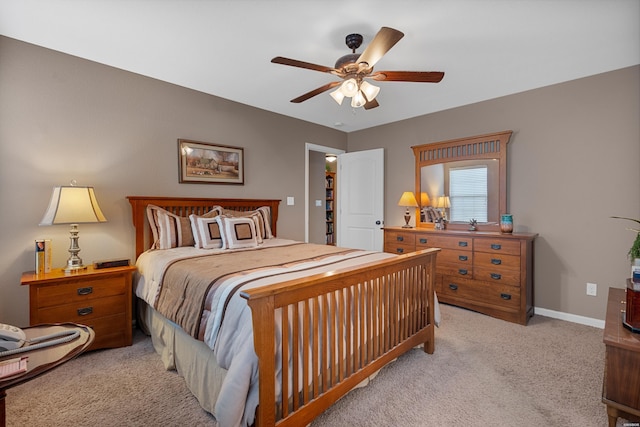 bedroom with baseboards, ceiling fan, and light colored carpet