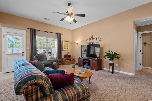 living room featuring light carpet, baseboards, visible vents, and a ceiling fan