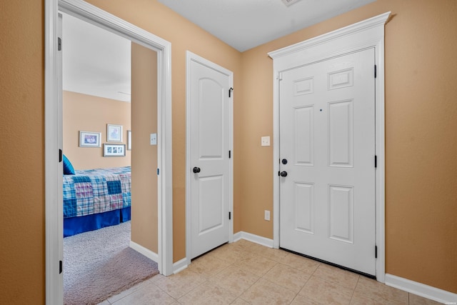 entrance foyer with baseboards and light tile patterned floors