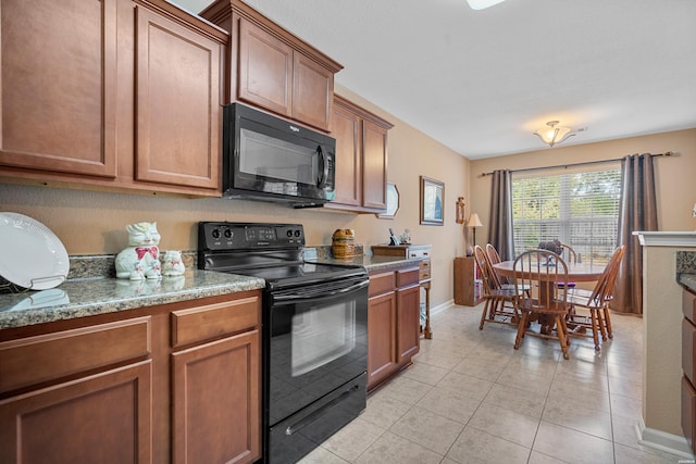 kitchen with light tile patterned floors, black appliances, baseboards, and brown cabinets