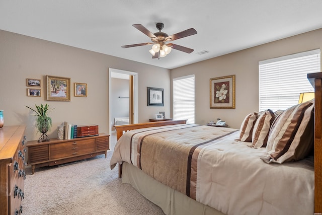 bedroom featuring light carpet, visible vents, and a ceiling fan