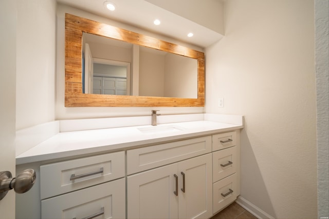 bathroom with recessed lighting, baseboards, and vanity