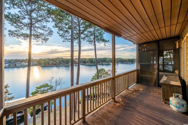 dock area with a water view and a balcony