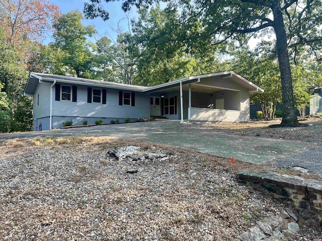 single story home with driveway, crawl space, and a carport