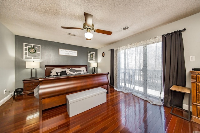 bedroom with visible vents, hardwood / wood-style flooring, and access to exterior