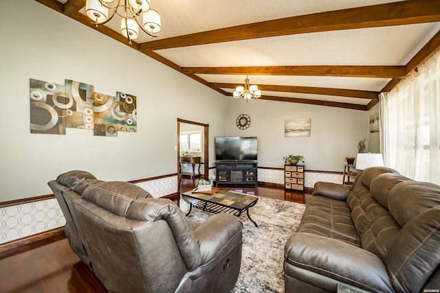 living area with lofted ceiling with beams, plenty of natural light, a textured ceiling, and a notable chandelier