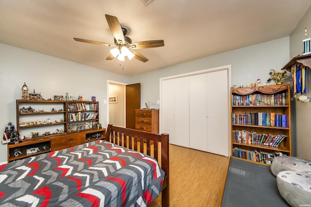 bedroom with a closet, wood finished floors, and a ceiling fan