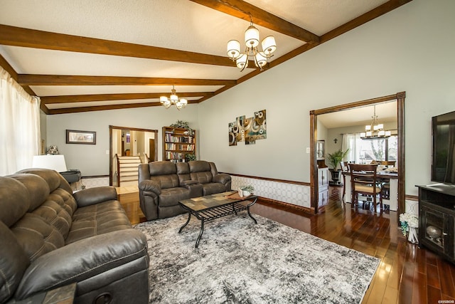 living room with dark wood-style floors, wainscoting, a notable chandelier, and lofted ceiling with beams