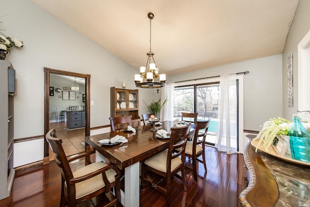 dining space with lofted ceiling, baseboards, dark wood-style floors, and a notable chandelier