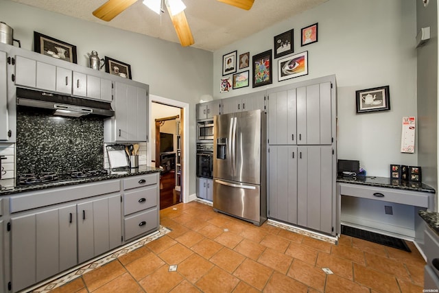 kitchen featuring gray cabinetry, under cabinet range hood, a ceiling fan, backsplash, and black appliances