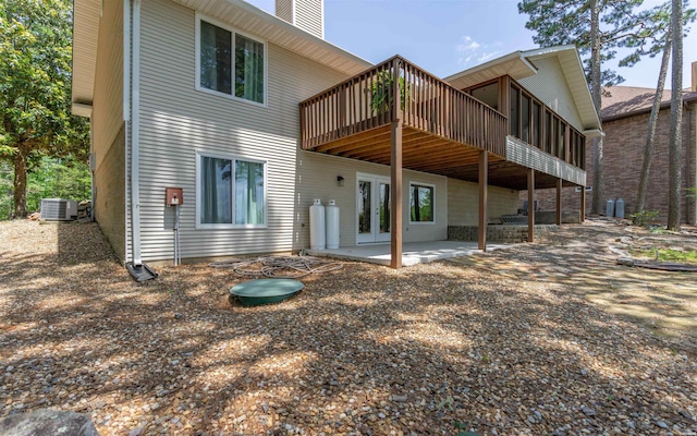 129 Mesero Way, Hot Springs Village, AR 71909 - back of house featuring a deck, central AC, a patio area, a chimney, and french doors