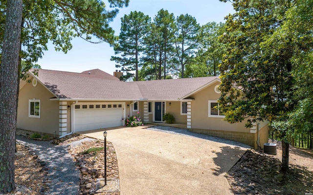 129 Mesero Way, Hot Springs Village, AR 71909 - view of front of home with driveway, a garage, roof with shingles, a chimney, and stucco siding