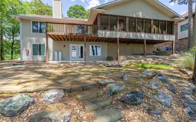 129 Mesero Way, Hot Springs Village, AR 71909 - back of house with a chimney, a sunroom, a wooden deck, and central air condition unit