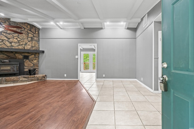foyer with a ceiling fan, beamed ceiling, and light wood finished floors