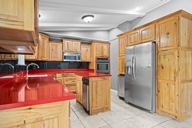 kitchen featuring appliances with stainless steel finishes, a sink, backsplash, a textured ceiling, and light tile patterned floors